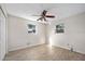An open and airy bedroom features wood-look flooring and two bright windows at 354 Georgetown Dr, Daytona Beach, FL 32118