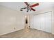 A bright bedroom with wood-look flooring and a closet with louvered doors at 354 Georgetown Dr, Daytona Beach, FL 32118