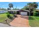 Inviting single-story home with a long driveway, mature landscaping and a well-manicured front lawn at 354 Georgetown Dr, Daytona Beach, FL 32118