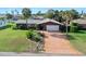 Inviting single-story home with a long driveway, mature landscaping and a well-manicured front lawn at 354 Georgetown Dr, Daytona Beach, FL 32118