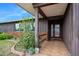 Charming front porch with tile flooring, brick accents, and lush landscaping at 354 Georgetown Dr, Daytona Beach, FL 32118