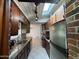 Bright kitchen features stainless appliances, tile floors, wooden cabinets, granite counters, and brick accents at 354 Georgetown Dr, Daytona Beach, FL 32118