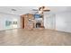 Open living area with brick fireplace, a ceiling fan, and sliding glass doors to the outdoors at 354 Georgetown Dr, Daytona Beach, FL 32118