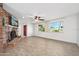 Cozy living room featuring a brick fireplace, wood-look floors, and ample natural light at 354 Georgetown Dr, Daytona Beach, FL 32118
