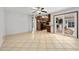 Large living room with tile floors, access to the kitchen, and sliding glass door to the patio at 354 Georgetown Dr, Daytona Beach, FL 32118
