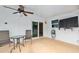 Covered patio featuring a ceiling fan, table set, and wall-mounted television for outdoor entertainment at 354 Georgetown Dr, Daytona Beach, FL 32118