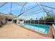 Spacious screened-in pool area with ample patio space for outdoor lounging and entertaining at 354 Georgetown Dr, Daytona Beach, FL 32118