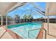 Inviting screened-in pool with clear blue water and a retractable pool cover for easy maintenance at 354 Georgetown Dr, Daytona Beach, FL 32118