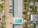 Aerial view of a building with a refreshing pool, nearby greenery, and ample parking at 3620 Cardinal Blvd # 80, Daytona Beach, FL 32118
