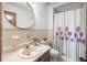 Well-lit bathroom featuring a vanity sink, toilet, and shower with a decorative curtain at 3620 Cardinal Blvd # 80, Daytona Beach, FL 32118