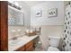 Clean bathroom with a tiled shower, vanity sink, and decorative fish artwork at 3620 Cardinal Blvd # 80, Daytona Beach, FL 32118