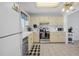 Functional kitchen with white cabinets, stainless steel appliances, and tile flooring at 3620 Cardinal Blvd # 80, Daytona Beach, FL 32118