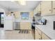 Well-lit kitchen featuring white cabinetry, appliances, and tile flooring at 3620 Cardinal Blvd # 80, Daytona Beach, FL 32118