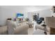 Comfortable living room features stylish furniture, TV, and a sliding door to the balcony at 3620 Cardinal Blvd # 80, Daytona Beach, FL 32118