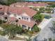 Aerial view of a townhome community showcasing well-manicured lawns and mature trees at 3620 Tresto St, New Smyrna Beach, FL 32168