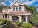 Charming townhome featuring a welcoming front porch, lush landscaping, and a well-maintained exterior at 3620 Tresto St, New Smyrna Beach, FL 32168