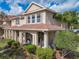 Charming two-story townhome featuring a covered front porch and well-maintained landscaping at 3620 Tresto St, New Smyrna Beach, FL 32168