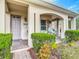 Inviting front entrance with a covered porch, neat landscaping, and a well-maintained walkway at 3620 Tresto St, New Smyrna Beach, FL 32168