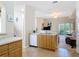 View of the kitchen flowing into the living room with sliding glass doors at 3620 Tresto St, New Smyrna Beach, FL 32168
