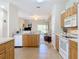 Open-concept kitchen featuring wood cabinets and view into the living room at 3620 Tresto St, New Smyrna Beach, FL 32168