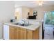 Cozy kitchen sink and counter area opening to the sunny living space at 3620 Tresto St, New Smyrna Beach, FL 32168