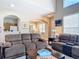 Spacious living room featuring dual reclining sofas and an archway into dining area at 3620 Tresto St, New Smyrna Beach, FL 32168