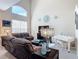 Inviting living room with high ceilings, recliner sofas, and a white piano at 3620 Tresto St, New Smyrna Beach, FL 32168