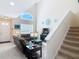 Bright, open-concept living room with staircase and cathedral window at 3620 Tresto St, New Smyrna Beach, FL 32168