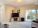 Living room with a ceiling fan, sliding glass doors to the patio, and neutral carpeting at 3620 Tresto St, New Smyrna Beach, FL 32168