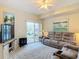 The living room offers a patio, natural light, ceiling fan and a cozy seating area at 3620 Tresto St, New Smyrna Beach, FL 32168