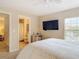 The main bedroom features a mounted TV and an ensuite bathroom at 3620 Tresto St, New Smyrna Beach, FL 32168