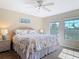 Bright main bedroom featuring sunlit windows, plush carpeting, and tranquil decor at 3620 Tresto St, New Smyrna Beach, FL 32168