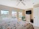 Sunny bedroom featuring multiple windows for natural light, ceiling fan, and neutral tones at 3620 Tresto St, New Smyrna Beach, FL 32168