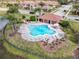 Community pool with seating, landscaping and clubhouse at 3620 Tresto St, New Smyrna Beach, FL 32168