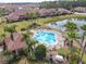 Community pool with seating, palm trees, and clubhouse at 3620 Tresto St, New Smyrna Beach, FL 32168
