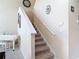 Carpeted staircase with white railings and neutral walls, leading to the upper level at 3620 Tresto St, New Smyrna Beach, FL 32168