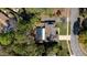 Aerial view of a home with a screened-in pool, driveway, and manicured lawn, surrounded by mature trees at 464 Nash Ln, Port Orange, FL 32127
