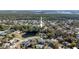 Aerial view of a home nestled in a lush, green neighborhood with a pond nearby at 464 Nash Ln, Port Orange, FL 32127