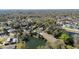 Aerial view of a beautiful home by a pond, surrounded by mature trees and lush greenery at 464 Nash Ln, Port Orange, FL 32127