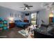 Cozy bedroom featuring a unique galaxy rug, dark wood floors, and a comfortable sofa at 464 Nash Ln, Port Orange, FL 32127