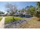 Charming home featuring a well-manicured lawn, and driveway with trees offering shade and curb appeal at 464 Nash Ln, Port Orange, FL 32127