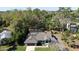 Well maintained one-story home with a gray roof, driveway, and a cozy front yard shaded by mature trees at 464 Nash Ln, Port Orange, FL 32127