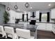 Charming kitchen with white cabinets, granite countertops, and modern lighting fixtures at 464 Nash Ln, Port Orange, FL 32127