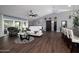 Open-concept living room featuring wood floors, modern furniture, a ceiling fan, and natural light at 464 Nash Ln, Port Orange, FL 32127