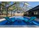 Serene pool area with lounge chairs inside of the screen enclosure, offering a relaxing backyard oasis at 464 Nash Ln, Port Orange, FL 32127