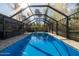 Clear blue pool surrounded by a screened enclosure, providing a private and refreshing outdoor retreat at 464 Nash Ln, Port Orange, FL 32127