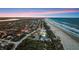 Wide aerial view of the beach community with ocean views, lush trees, and scenic waterfront living at it's best at 4911 S Atlantic Ave, Ponce Inlet, FL 32127