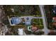 Overhead view of a stunning estate with manicured grounds, circular driveway, a pool, and mature landscaping at 4911 S Atlantic Ave, Ponce Inlet, FL 32127