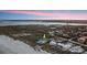 Wide aerial view of beachfront property with river views, lush trees, and scenic waterfront living near the beach at 4911 S Atlantic Ave, Ponce Inlet, FL 32127