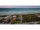 Expansive aerial perspective of a stunning beach home nestled among verdant greenery, offering unparalleled coastal living at 4911 S Atlantic Ave, Ponce Inlet, FL 32127